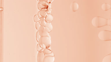 Beige transparent bubbles form and float to another ones