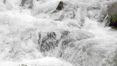 Mountain river stream with waterfalls over stone cascades