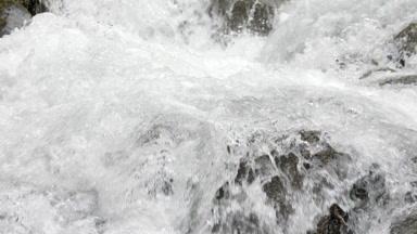 Mountain river stream with waterfalls over stone cascades