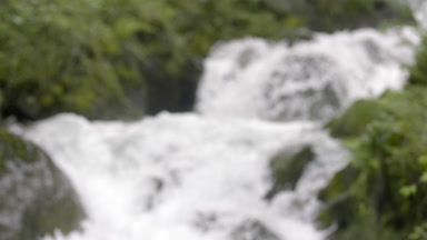 Fast flowing Swiss mountain river with green coasts