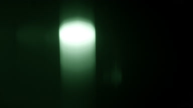 Green light leak overlay vertical glowing spot effect