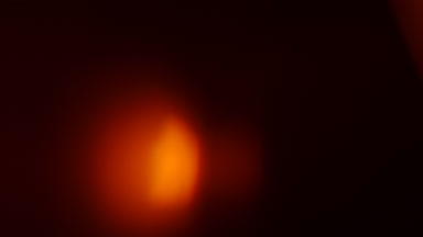 Warm orange light leak glowing spot moves bottom to top