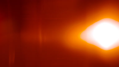 Warm light leak overlay: luminous spot moves up