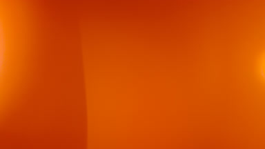 Warm light leak flare rising upward overlay
