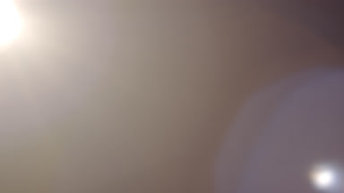 Neutral light leak overlay with vertical ghosting flare