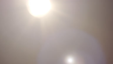 Neutral light leak overlay spot moves left to right flares