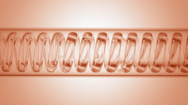 Clear liquid in horizontal coil condenser on beige ramp