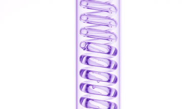 Clear liquid in vertical coil condenser on white background