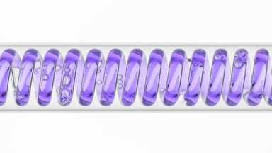 Violet liquid in horizontal coil condenser on white background