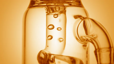 Orange hydrosol bubbles condense and move in glass tube