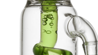Lime peel extract in glass tube, bubbles condense, swirl inside