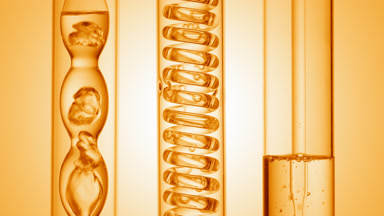 Clear liquid with bubbles rising in lab condensers, yellow ramp