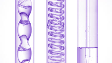 Clear liquid bubbles in bulb condenser, glass coil on white