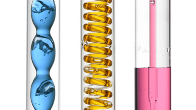 Blue, yellow, pink bubbling in condenser, filling tube on white