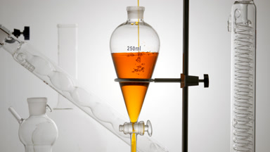 Marigold infusion pours in funnel, bubbles rising underwater
