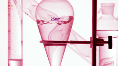 Make-up remover injected, waves forming inside the flask