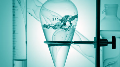 Pale cyan liquid injected, splashes inside on cyan background