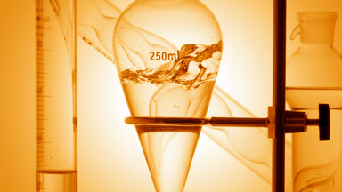 Orange hydrosol injected, filling vessel and creating splashes
