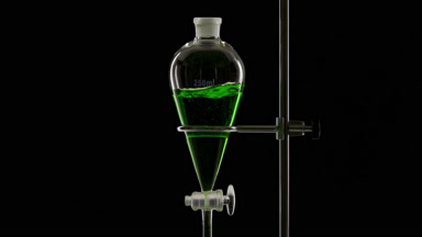 Green liquid injected in funnel, splashes appear on black