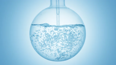 Oxygenated water dropper injection swirls and bubbles in flask