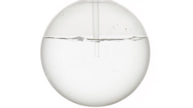 Peppermint hydrosol dropper injection swirls, bubbles in flask