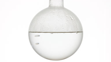 Clean water gently boils in round-bottom flask, condensing