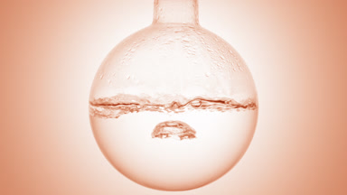 Clear liquid boiling in flask, condensation on beige ramp bg