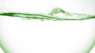 Clear liquid boiling in flask, bubbles and waves, grey bg
