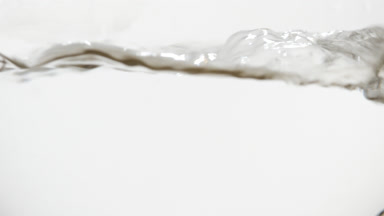 Mineral water boiling in flask, bubbles and waves displayed