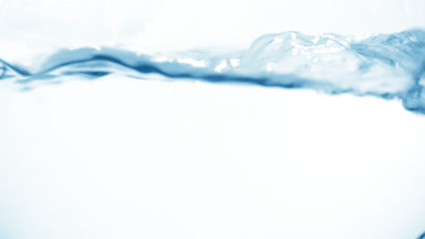 Micellar water boiling in flask, bubbles and waves visible