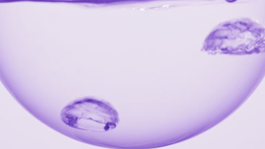 Fragrance boiling in round flask, bubbles forming upward