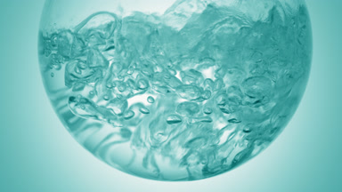 Clear liquid boiling in flask, bubbles on cyan ramp bg