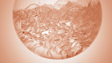 Clear liquid boiling in flask, bubbles on beige ramp bg