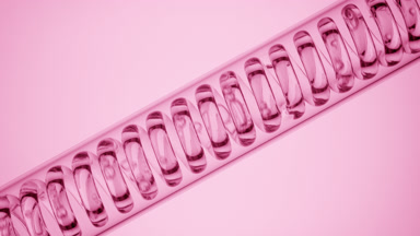 Clear liquid in inclined coil condenser on pale pink, filling