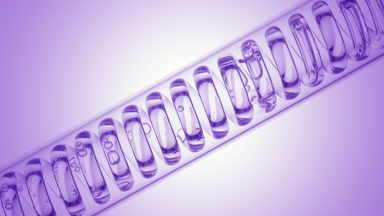 Clear liquid in inclined coil condenser on purple ramp, fill