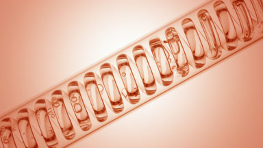 Clear liquid in inclined coil condenser on beige ramp, fill