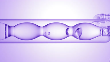 Clear liquid drains from bulb condenser, purple ramp background