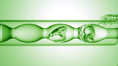 Isopropyl alcohol drains from bulb condenser, process close-up