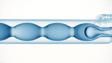 Blue liquid fills and drains bulb condenser, white background