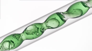 Cucumber extract flowing in inclined bulb condenser, lab visuals