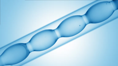 Pale blue liquid in inclined bulb condenser, blue ramp scene