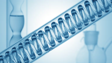 Blue liquid bubbling in lab coil, bulb condenser on blue ramp