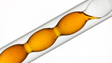 Vitamin c solution mixing in flask, refractive swirls effect