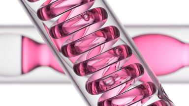 Pink liquid bubbling in spiral coil, bulb condenser on white