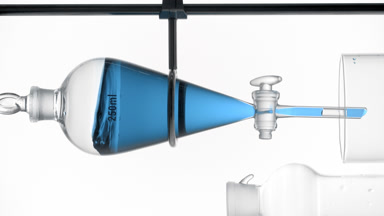Methylene blue solution waves along flask walls, lab process