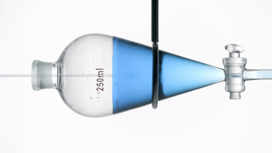 Blue liquid in funnel creates refractive swirls schlieren effect
