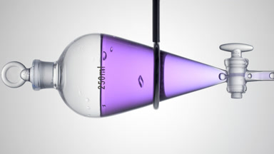 Purple carrot extract dripping from separatory funnel, bubbles