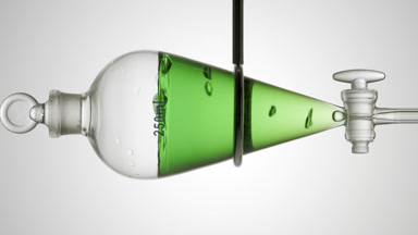 Green liquid with rising bubbles on light grey background view