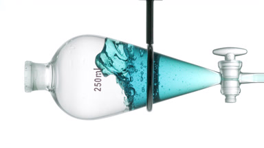Cyan liquid injected in funnel, splashes on white background