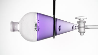Violet transparent liquid with rising bubbles, grey backdrop